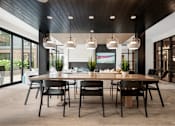 Thumbnail 41 of 41 - A modern dining room with a wooden table and chairs.