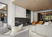 Thumbnail 39 of 41 - A modern living room with a fireplace and couches.
