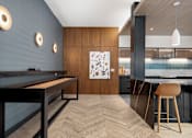 Thumbnail 36 of 41 - A modern kitchen with a pool table.