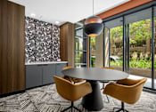 Thumbnail 30 of 41 - A conference room with a round table and chairs.