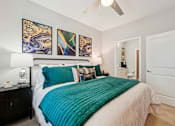 Thumbnail 22 of 64 - A bedroom with a large bed and a ceiling fan.