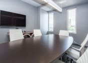 Thumbnail 19 of 33 - a conference room with a large table and chairs and a television