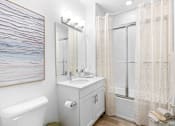 Thumbnail 9 of 35 - a bathroom with a sink and a shower