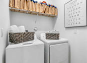 Thumbnail 10 of 35 - two washers and dryers in a laundry room with a calendar on the wall