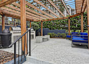 Thumbnail 58 of 61 - A wooden pergola with a metal railing and a concrete floor.