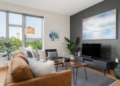 Thumbnail 38 of 45 - a living room with a couch and a television at Verge Apartments in St. Louis Park, MN