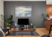 Thumbnail 37 of 45 - a living room with a coffee table and a television at Verge Apartments in St. Louis Park, MN