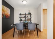 Thumbnail 35 of 45 - a dining room with a table and chairs and a black wall at Verge Apartments in St. Louis Park, MN