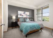 Thumbnail 41 of 45 - a bedroom with a bed and a large window at Verge Apartments in St. Louis Park, MN
