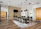 Thumbnail 8 of 45 - a dining room with a table and chairs and a fireplace at Verge Apartments in St. Louis Park, MN