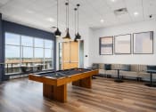 Thumbnail 11 of 45 - an open room with a pool table and couches at Verge Apartments in St. Louis Park, MN