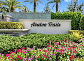 Thumbnail 34 of 35 - a sign that says avalon trails in front of flowers