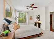 Thumbnail 9 of 48 - a bedroom with a bed and a ceiling fan