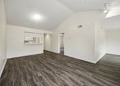 Thumbnail 2 of 21 - A room with wooden flooring and white walls.