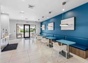 Thumbnail 28 of 35 - a restaurant with blue walls and tables and chairs