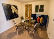 Thumbnail 21 of 64 - A living room with a black and white painting on the wall.