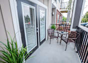 Thumbnail 18 of 64 - A patio with a table and chairs is shown.