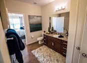 Thumbnail 11 of 64 - A bathroom with a toilet, sink, and mirror.