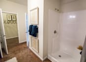 Thumbnail 9 of 64 - A bathroom with a white tub and a blue towel hanging on the door.