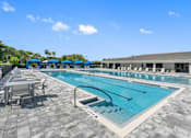 Thumbnail 18 of 35 - a swimming pool with tables and chairs around it