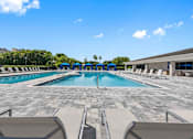 Thumbnail 25 of 35 - a swimming pool with chairs and umbrellas at the resort