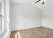 Thumbnail 27 of 61 - A room with wooden flooring and white walls.