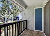 Thumbnail 32 of 61 - A blue door is on the right side of a white wall.