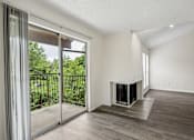 Thumbnail 9 of 21 - A modern living room with a fireplace and sliding glass doors.