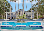 Thumbnail 54 of 61 - A house with a pool in front of it.
