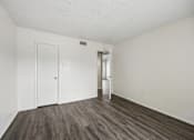 Thumbnail 10 of 21 - A room with a white door and a white wall.