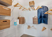 Thumbnail 84 of 95 - a closet with baskets and hooks and a bag on a rack