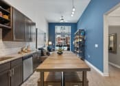 Thumbnail 83 of 95 - an open kitchen and dining room with a large wooden table
