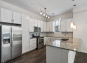 Thumbnail 94 of 95 - a kitchen with stainless steel appliances and granite counter tops
