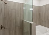 Thumbnail 89 of 95 - a bathroom with a shower and a toilet and a sink