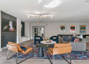 Thumbnail 8 of 39 - a living room with a couch and chairs and a table