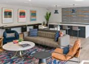 Thumbnail 7 of 39 - a living room with couches tables and chairs and a bar