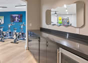 Thumbnail 17 of 39 - a fitness center with exercise bikes and a mirror on the wall