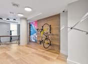 Thumbnail 19 of 39 - a bike is hanging on a wall in a room with wood floors and a wall
