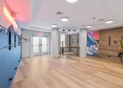 Thumbnail 18 of 39 - a workout room with a bike rack and a wall with a mural