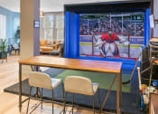 Thumbnail 6 of 39 - a dining room with a table and chairs and a large screen tv