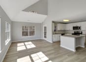 Thumbnail 3 of 35 - a living room with a kitchen and a large window