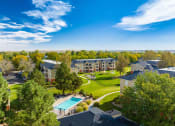 Thumbnail 24 of 25 - an aerial view of an apartment complex with a green lawn and a pool