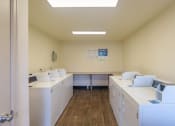 Thumbnail 9 of 25 - an empty room with washing machines and dryers