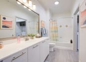 Thumbnail 27 of 39 - a bathroom with a large mirror and a toilet and a shower