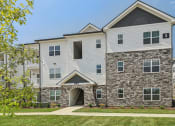 Thumbnail 21 of 36 - an apartment building with a stone and white facade