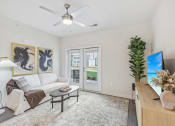 Thumbnail 12 of 36 - a living room with a white couch and a ceiling fan