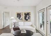 Thumbnail 11 of 36 - a living room with a white couch and two paintings on the wall