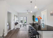 Thumbnail 9 of 36 - a living room with a kitchen and a dining room