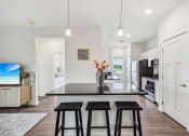 Thumbnail 5 of 36 - a kitchen with a center island and three stools