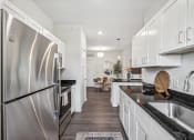 Thumbnail 7 of 36 - a kitchen with stainless steel appliances and white cabinets